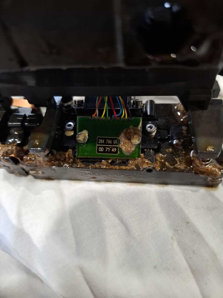 5. Top view of the contamination of the scanning head, that left much longer could have compromised the electronics of the scanning head rendering the unit